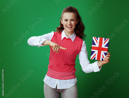 learner woman pointing at United Kingdom flag coloured notebook © Alliance