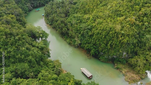 Aerial view on Loboc River in Bohol, Philippines. Tropical rainforest, canyon, jungle, boats, rocks, stream / 4K Drone Video