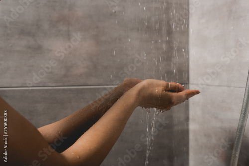 cropped view of woman taking shower in cabin