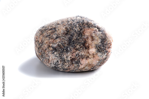 Rough round granite stone isolated on white background