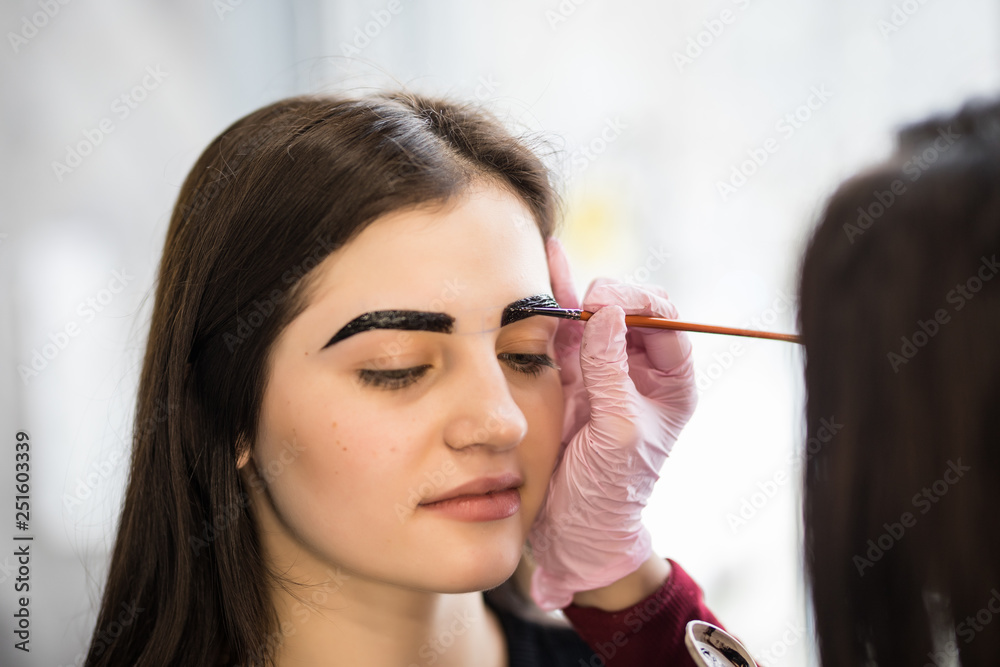 Young woman having brow color added to her eyebrows