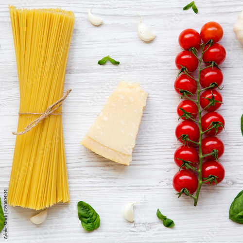 Pasta background. Ingredients for cooking pasta on a white wooden background. Flat lay. From above. Top view, overhead.