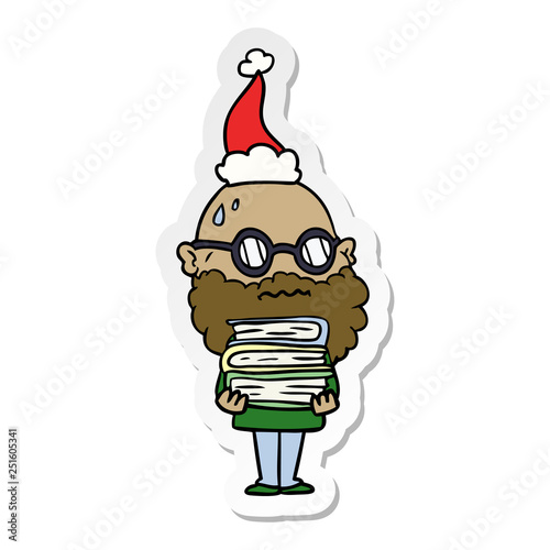 sticker cartoon of a worried man with beard and stack of books wearing santa hat