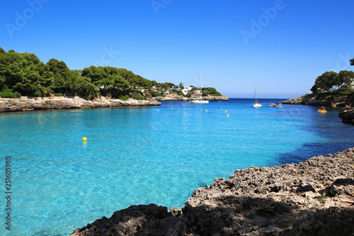 Beautiful Cala d'Or Beach in sunny summer day with turquoise water. Beach Cala Gran in Cala d'Or, Mallorca, Spain. Beautiful mediterranean landscape.