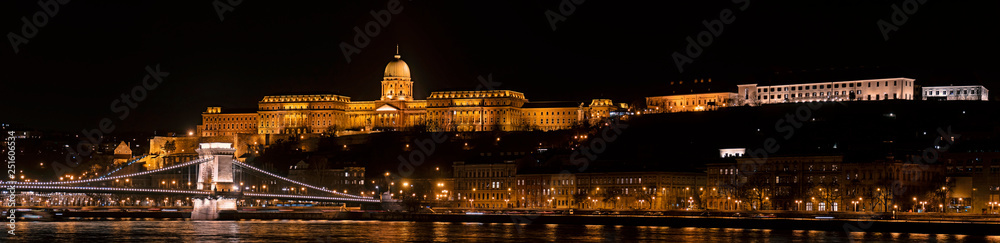 Panoramic landscape of Budapest with the Chain Bridge, Buda Castle, Presidental Palace and the Carmelite Monastery by night