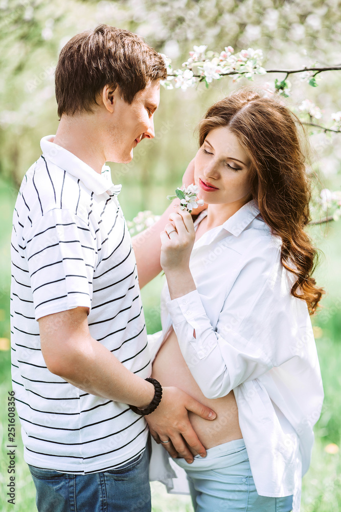 Portrait of lovely future parents during sunset on nature apple tree background Portrait of lovely future parents during sunset on nature apple tree background