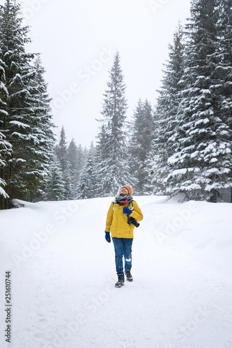 Photoigrapher on the road in winter forest