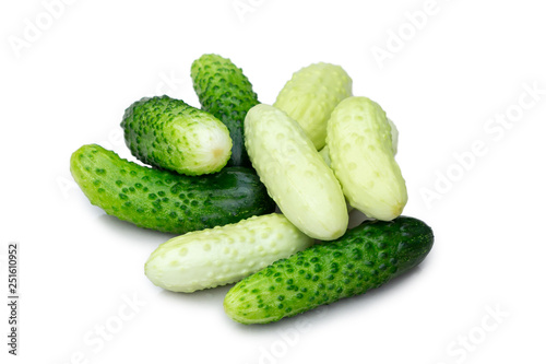 Several small cucumbers gherkins of different varieties isolated on white background