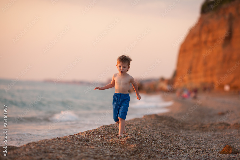 cute baby boy playing at the sea