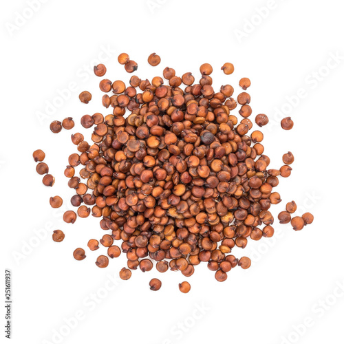 Small pile of red or brown quinoa seeds seen directly from above and isolated on white background