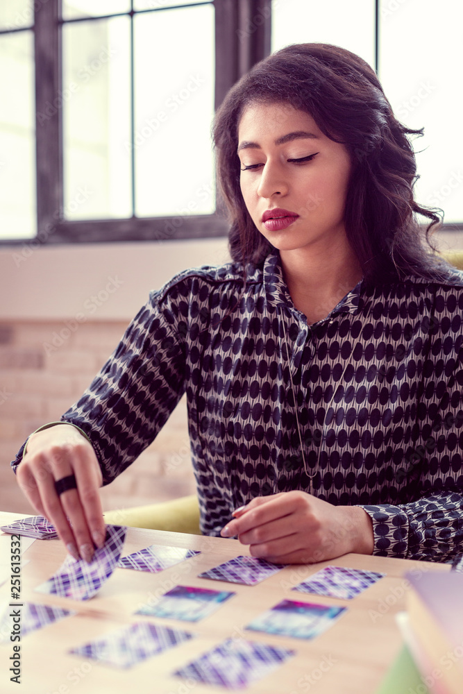 Fototapeta premium Serious good looking woman focusing on her work