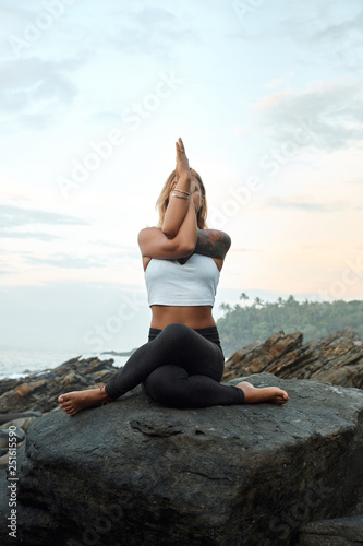 Woman Practicing Yoga in the Nature. Meditating Outdoors
