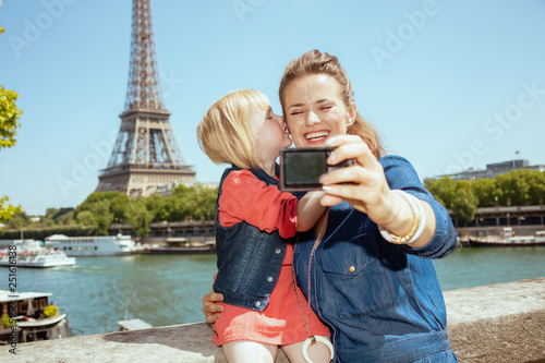 mother and child tourists taking selfie with digital camera photo