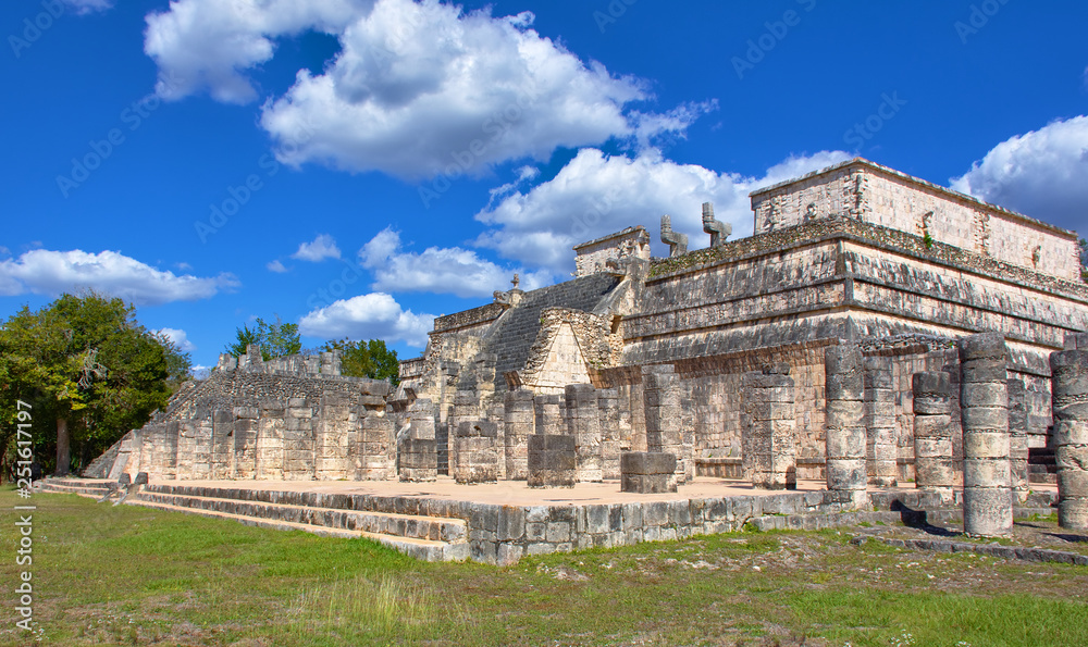 Sunny day with blue sky and white clouds. No people around. Mayan ruin. Templo de Los Guerreros (Temple of The Warriors) in Yucatan, Mexico - Mar 2, 2018