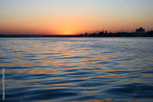 sunset over the calm black sea with seagulls © Katerina Novitskaya