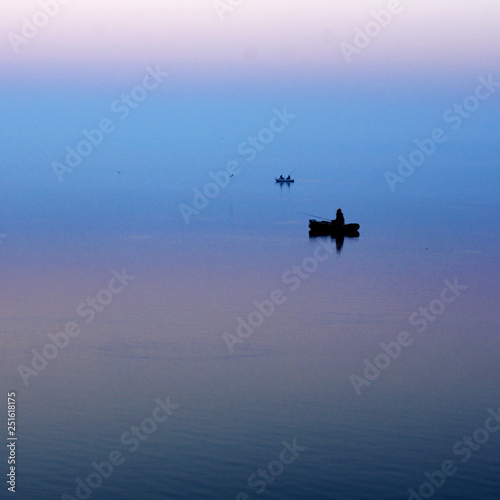 Fototapeta Naklejka Na Ścianę i Meble -  lonely boat in the fog early in the morning