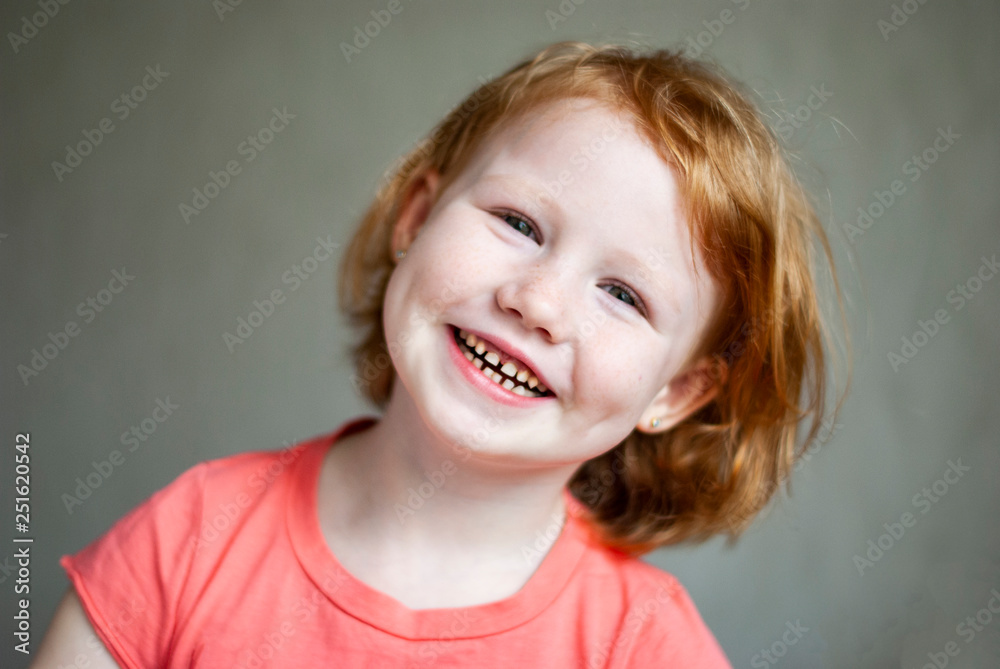 Studio shot of cute happy and emotive young redhead girl in pink t-shirt smiling feeling happiness. Studio shot of cute happy and emotive young redhead girl in pink t-shirt smiling feeling happiness.