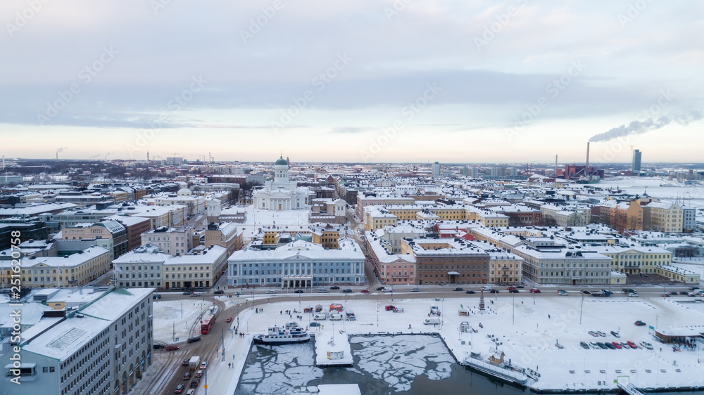 Ariel panoramic view of Helsinki at winter with a Cathedral church and Market Square area on the shore of Baltic Sea. 