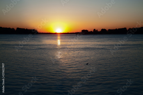 Sunset on the river in Nizhny Novgorod. Bright ray of light on the water surface