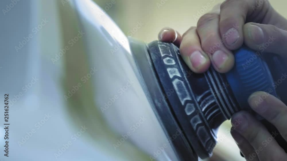 Headlight Polishing, processing of car lights. A car service worker polishes the headlight of a passenger car with a special polishing tool. Professional polishing