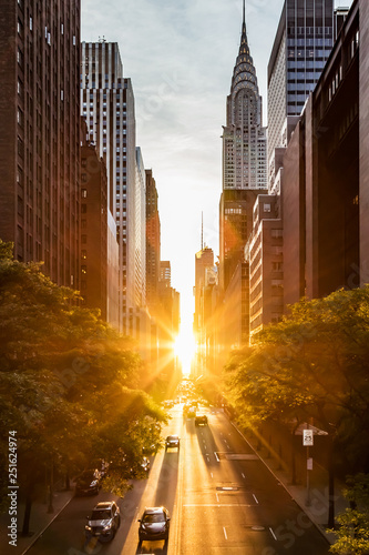 Sunset light shining on the buildings and cars on 42nd Street in Midtown New York City around the time of the Manhattanhenge summer solstice
