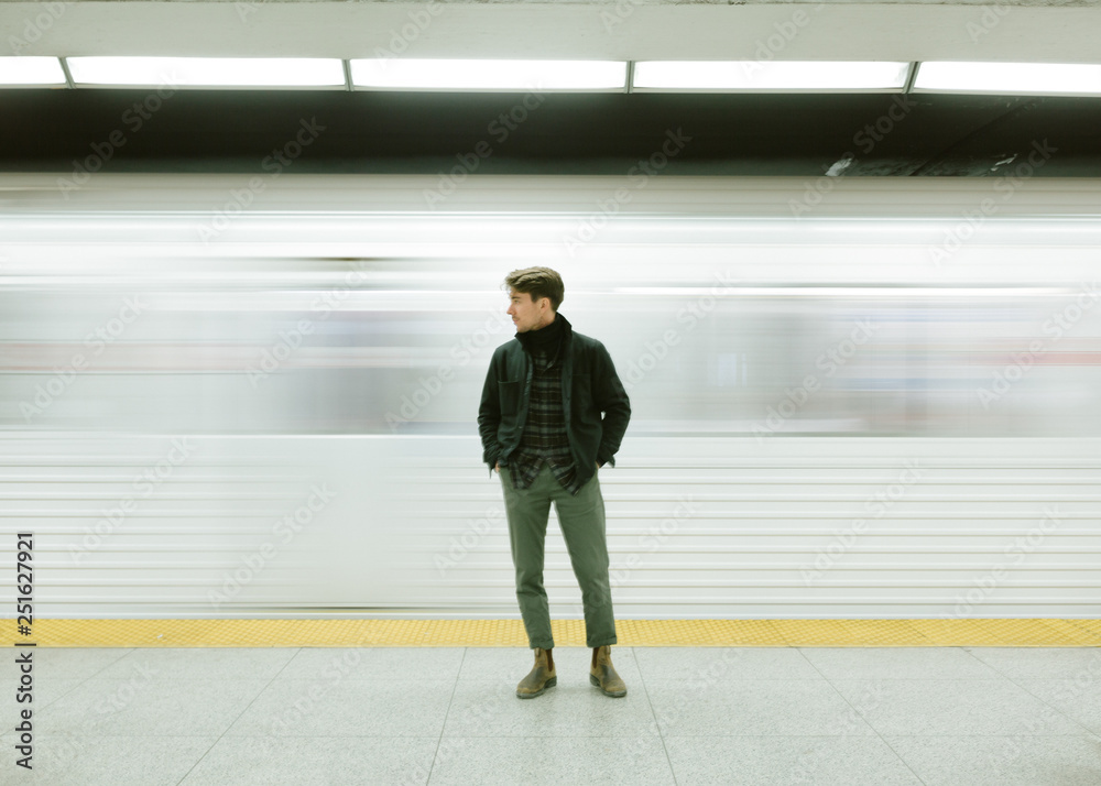 Man standing on railway platform Man standing on railway platform