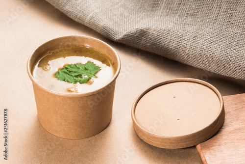 Soup in a disposable cup of craft paper