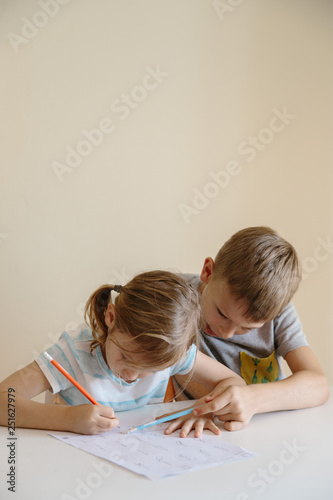 Brother helping his sister to do homework