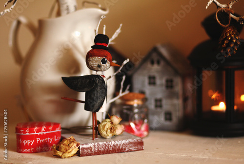 Fun wooden bird sparrow in the hat and dinner jacket with dried rose.