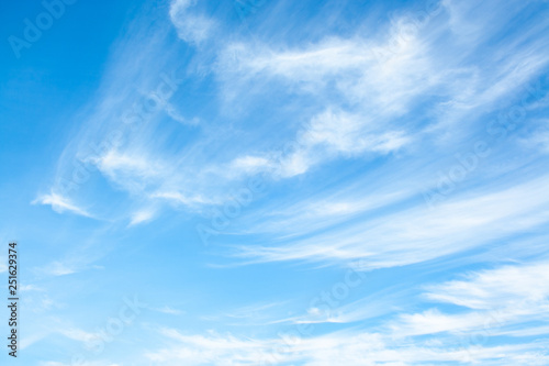 White clouds high in the sky at windy winter day background photo