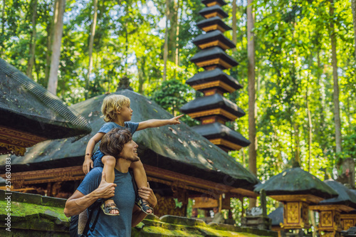 Dad and son travelers discovering Ubud forest in Monkey forest, Bali Indonesia. Traveling with children concept photo