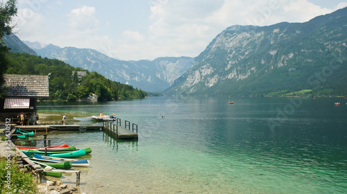 Picturesque view of the lake Bohinj, Julian Alps mounntains and boats, Slovenia