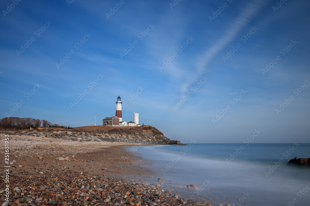The Atlantic ocean meeting the east coast of Long Island, as the Montauk Lighthouse beacon sits at the tip of the island. - Long Island, New York. 