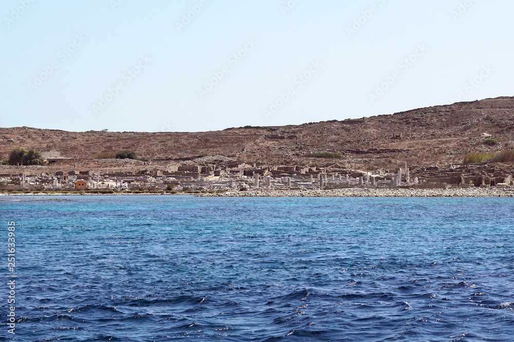 Beautiful view of the archaeological site of Delos from the ferry in the Cyclades Islands