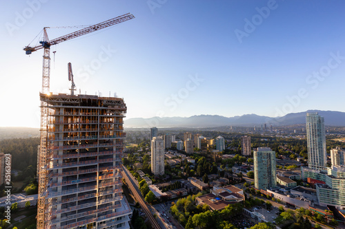 Obraz na płótnie Aerial view of a residential building construction site during a vibrant summer sunset. Taken in Burnaby, Vancouver, BC, Canada.