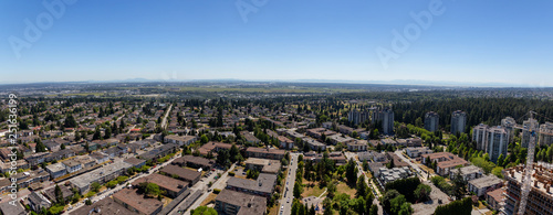Aerial view of a residential suburban neighborhood during a sunny summer evening. Taken in Burnaby, Vancouver, BC, Canada.