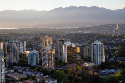 Aerial view of a modern city during a vibrant sunset. Taken in Metrotown, Burnaby, Vancouver, BC, Canada.