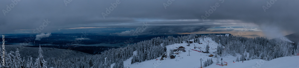 Panoramic view of Grouse Mountain Ski Resort during a cloudy winter sunset. Taken in North Vancouver, British Columbia, Canada. Panoramic view of Grouse Mountain Ski Resort during a cloudy winter sunset. Taken in North Vancouver, British Columbia, Canada.