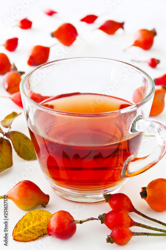 Rose hip tea and glass cup with fruits