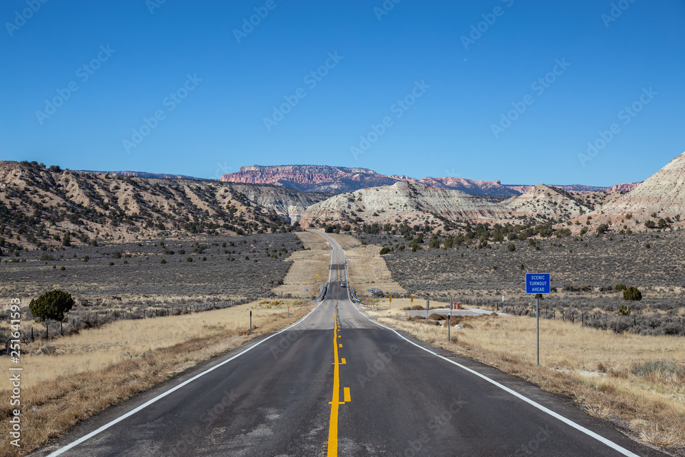Scenic road in the desert during a vibrant sunny day. Taken on Route 12, Utah, United States of America.