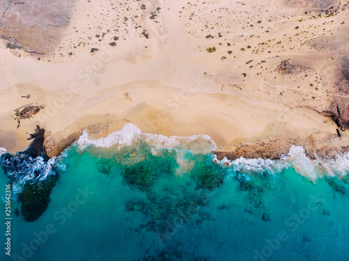 Aerial view of clean sandy beach by ocean