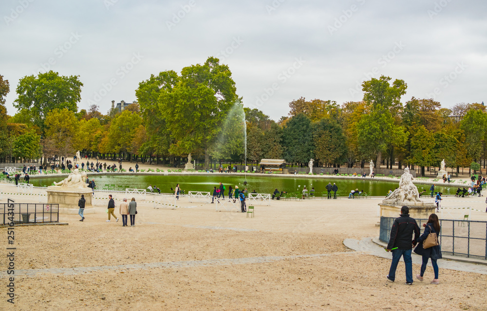 PARIS, FRANCE - 02 OCTOBER 2018: People in Tuileries park, one of the most beautiful in Paris PARIS, FRANCE - 02 OCTOBER 2018: People in Tuileries park, one of the most beautiful in Paris