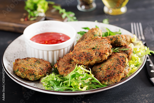 Home made Fish Cake cod, spinach and breadcrumbs. Served on plate with sauce. Cutlets from minced cod. Delicious and nutritious lunch or dinner.