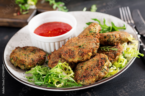 Home made Fish Cake cod, spinach and breadcrumbs. Served on plate with sauce. Cutlets from minced cod. Delicious and nutritious lunch or dinner.