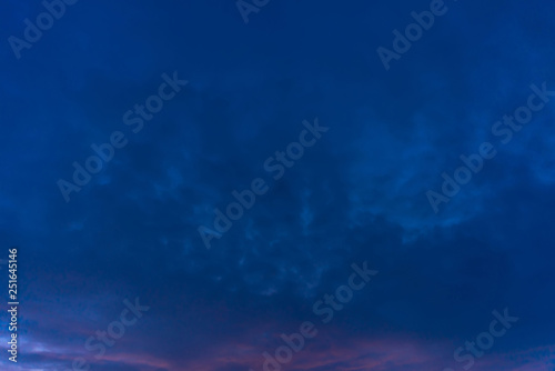 Amazing dramatic blue cloudy sky nightly. Atmospheric minimalist natural background of night in overcast weather. Hard cloudiness. Storm clouds warning. Beautiful dark cloudscape. Darkness. Copy space