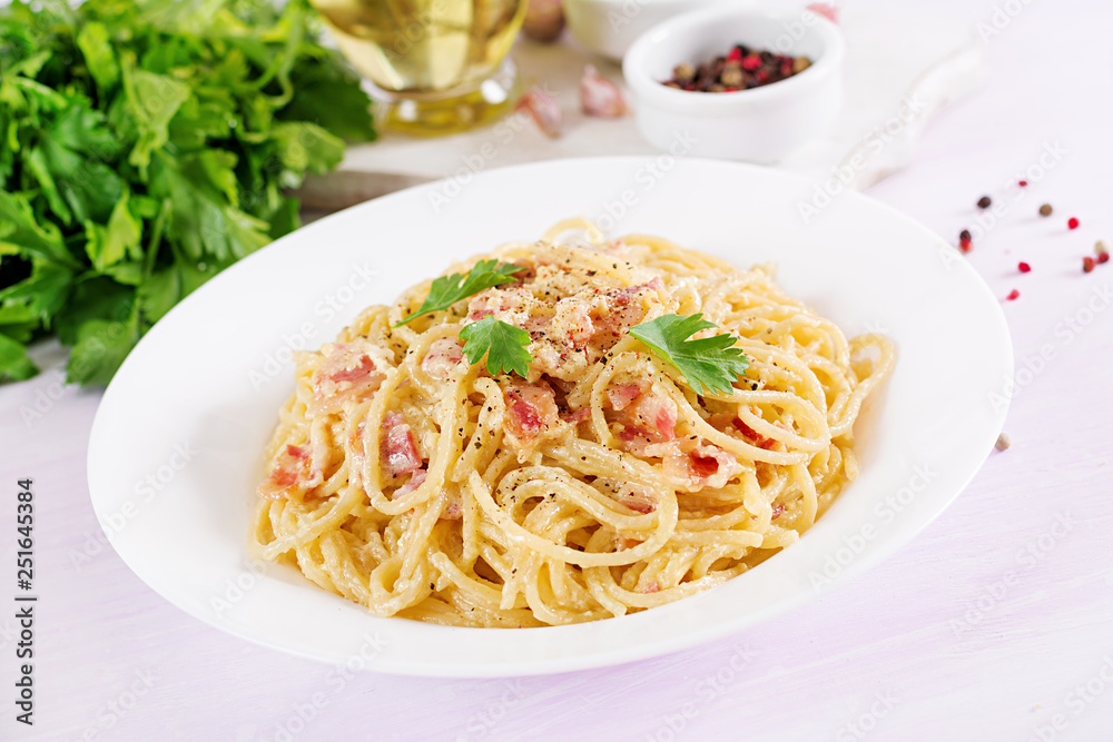 Classic homemade carbonara pasta with pancetta, egg, hard parmesan cheese and cream sauce. Italian cuisine. Spaghetti alla carbonara.