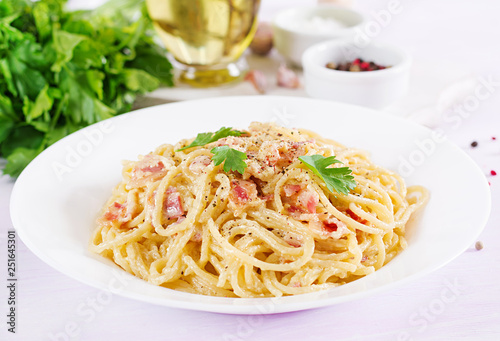 Classic homemade carbonara pasta with pancetta, egg, hard parmesan cheese and cream sauce. Italian cuisine. Spaghetti alla carbonara. photo