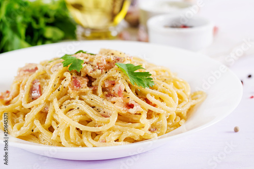 Fototapeta Classic homemade carbonara pasta with pancetta, egg, hard parmesan cheese and cream sauce