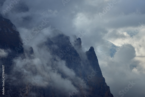 Clouds and mist cover the mountains during bad weather in Lauterbrunnen valley in Switzerland.