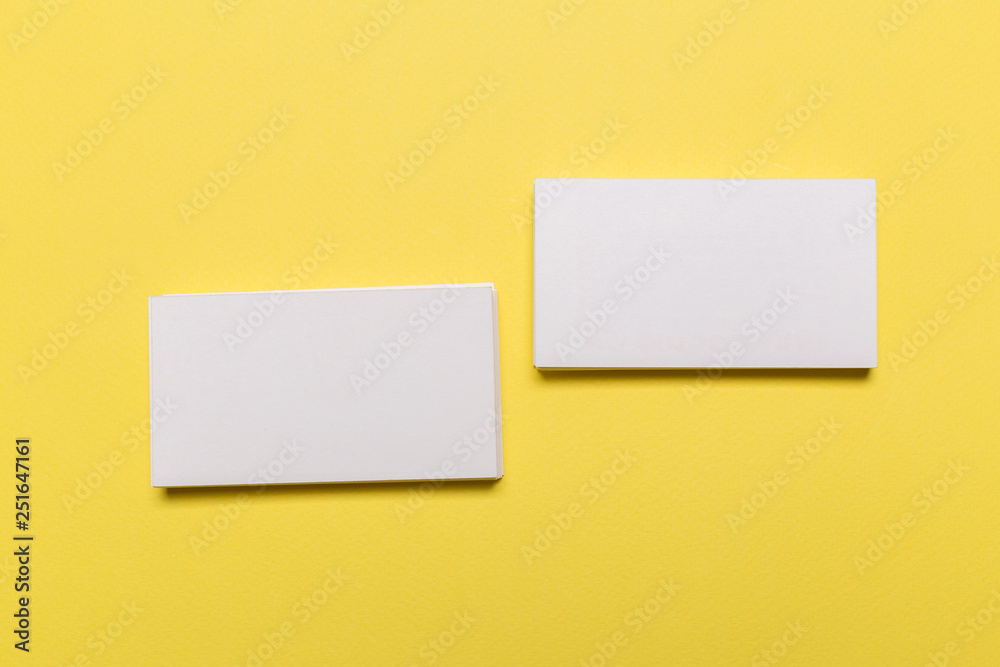 Blank white business cards on yellow background. Mockup for branding identity. Blank white business cards on yellow background. Mockup for branding identity.